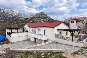 a villa with a view of the mountains at Apartmani Mia in Karlobag