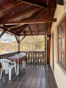a patio with a table and chairs on a wooden deck at AA Apartman - Tópart in Kaposvár