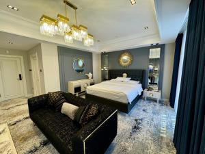 a large bedroom with a bed and a couch at Hotel Sultan in Qarshi +49 photos