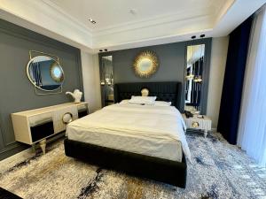 a bedroom with a large bed and a mirror at Hotel Sultan in Qarshi