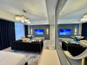 a hotel room with a bed and a living room at Hotel Sultan in Qarshi