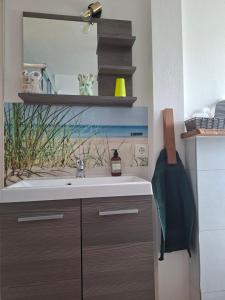 a bathroom with a sink and a mirror at Pension Fiete Celle in Celle +14 photos