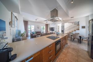 a kitchen and living room with a large counter top at Palm Villa Eva in Paralimni