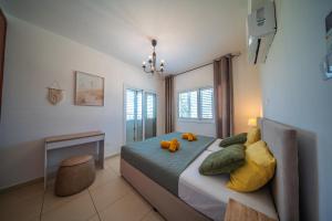 a bedroom with a bed with a teddy bear on it at Palm Villa Eva in Paralimni +47 photos