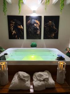 a bathroom with a bath tub with three pictures on the wall at il tramonto in Capaci +56 photos