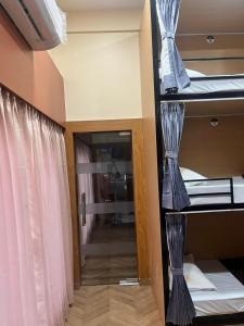 a room with two bunk beds and a mirror at Bachelor Stay - CBD Belapur in Navi Mumbai