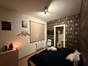 a bedroom with a bed and a projection screen at il tramonto in Capaci