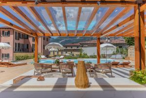 a patio with a table and chairs and a swimming pool at Appartamento Bianca in Bellagio