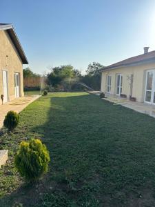 a yard of a house with a large lawn at Villa Alba in Ezerets +16 photos