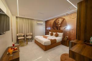 a hotel room with a bed with a head on the wall at The Muse Luxury View Hotel in Cairo