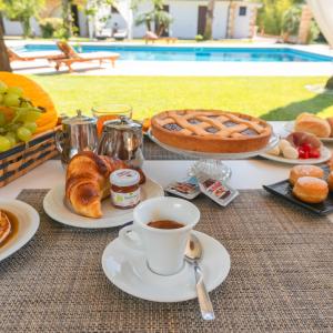 a table with breakfast foods and a cup of coffee at Villa Padula in Sogliano Cavour