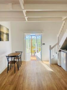 a room with a table and chairs and a staircase at Quinta da Bela Vista in Lagos