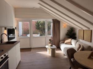 a living room with a couch and a table at Beach House Zandvoort in Zandvoort
