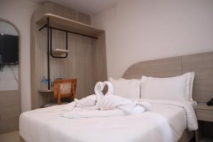 a bed with two swans made out of towels at Hotel Kantipur Plaza in Nepālganj