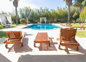 a couple of chairs and a swimming pool at Villa Padula in Sogliano Cavour