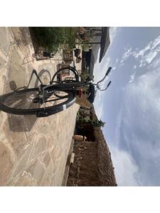 a bike hanging on the side of a wall at Lodge bio berber nomad in Nkob