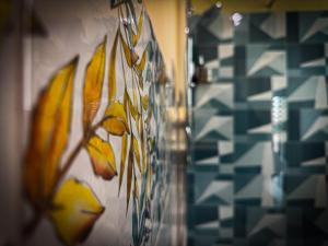 a bunch of bananas hanging on a wall at ToNo House in Paterno +26 photos