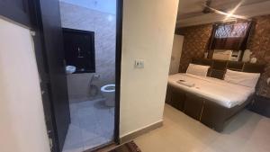 a bathroom with a toilet and a sink and a shower at jai shree hotel in Noida