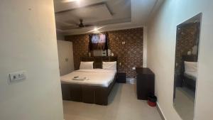 a small bedroom with a bed in a room at jai shree hotel in Noida