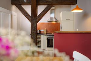 a kitchen with a table and a red counter top at Brauhaus am Schloss in Gartow