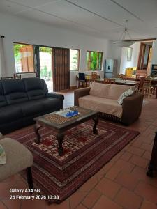a living room with a couch and a coffee table at 21A On VDR in Oudtshoorn