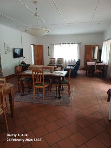 a living room with a table and chairs at 21A On VDR in Oudtshoorn