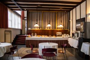a restaurant with two tables and chairs and a counter at Hotel Napoleon Rimini - City & Station in Rimini