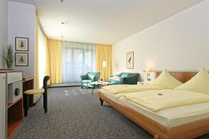 a hotel room with a bed and a living room at Hotel Hirschen in Glottertal +52 photos