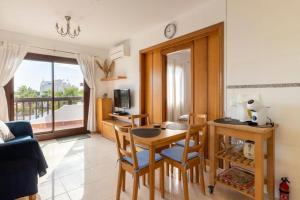 a living room with a table and chairs and a room at Marina d'Or III - Villa 10 in Santanyi
