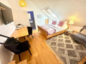 a bedroom with a bed and a table and a couch at VILLA ORCHARD Frankfurt - Trade Fair Airport in Kriftel