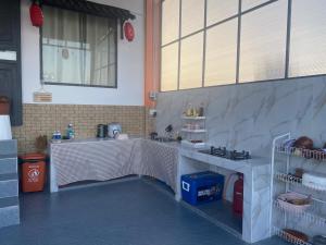 a kitchen with a table and a sink in a room at Gạo homestay Dốc lết in My Luong