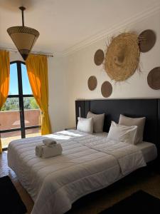 a bedroom with a bed with a basket on the wall at DOMAINE DU DOUAR in Marrakesh +35 photos