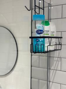 a shelf in a bathroom with toiletries on it at Stylish 2 Bedroom Coastal Apartment near Crosby Beach & Liverpool in Waterloo +34 photos
