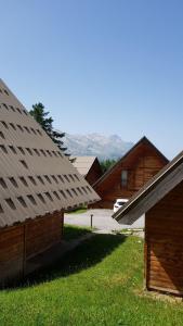 a group of roofs of buildings with mountains in the background at Flocons du Soleil by Actisource in La Joue du Loup