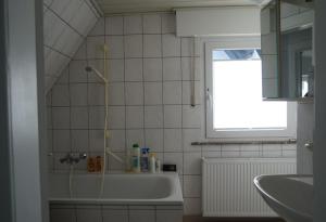 a bathroom with a bath tub and a window at Ferienwohnung in der Region Warstein in Warstein +17 photos