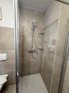 a shower with a glass door in a bathroom at Pension am Markt in Lübben +40 photos