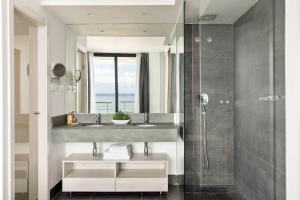 a bathroom with a sink and a shower at Santa Romana Apartments & Suites in Caldes d'Estrac +18 photos