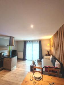 a living room with a bed and a table at Gites du Rioul in Les Estables