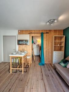 a room with a desk and a table and a bed at Gites du Rioul in Les Estables +20 photos