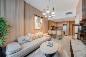 a living room with a couch and a table at The Clay Loft Stylish 1BR with Pool Parking CB2-1-RA2-707-1br in Sharjah