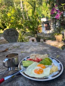 a plate of eggs and vegetables on a table at Heritage Eco Garden in Dickwella