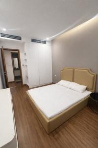 a bedroom with a large white bed in a room at BRG Luxury Apartments in Hai Phong