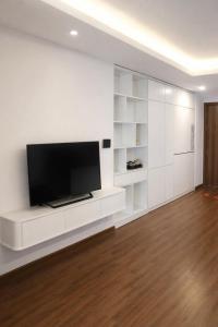 a living room with a flat screen tv on a white wall at BRG Luxury Apartments in Hai Phong