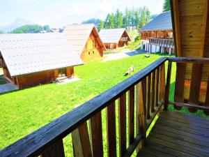 a balcony of a cabin with a view of a yard at Flocons du Soleil by Actisource in La Joue du Loup
