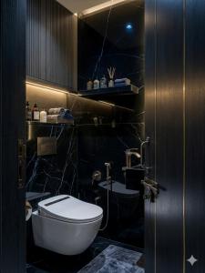 a bathroom with a white toilet and a sink at Hotel The Tark Near Delhi Airport in Champawat +26 photos
