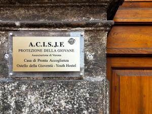 a sign on the side of a building at Protezione della Giovane - female hostel in Verona