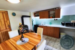 a kitchen with a wooden table and a stove at Chata MIMONKA in Dedinky +11 photos