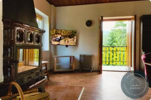 a living room with an old wood stove and a door at Chata MIMONKA in Dedinky