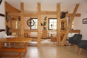a dining room with wooden furniture and a table at Doppelzimmer mit Bad in Möllenhagen