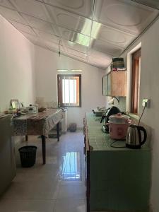 a kitchen with green counters and a table in it at Heritage Eco Garden in Dickwella +34 photos